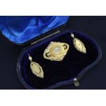 A cased Victorian gold and rose cut diamond set demi parure, comprising a brooch and a pair of