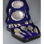 A cased George V thirteen piece engine turned silver dressing table set by Charles & Richard Comyns,