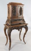 A late 19th century Black Forest relief carved wood cabinet on stand, decorated in relief throughout