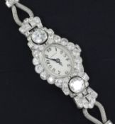 A lady's 1950's white gold and diamond set Vertex manual wind cocktail watch, with oval Arabic dial,