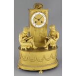 A French Empire ormolu mantel clock, modelled as a bookcase flanked by two children reading books,