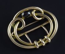 A Victorian 9ct gold and almandine garnet set buckle, of scrolling form, in original case, 2.5in.