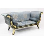 A Regency style parcel gilt green painted settee, with scroll ends and foliate decoration, W.6ft