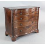 A George III mahogany serpentine fronted chest, with brushing slide and four graduated long drawers,