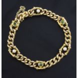 An Edwardian 15ct gold, peridot & seed pearl set curb link bracelet, 6.5in