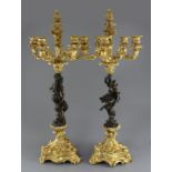 A pair of Louis XVI style bronze and ormolu five light candelabra, with faun and maiden stems, H.