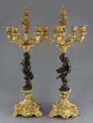 A pair of Louis XVI style bronze and ormolu five light candelabra, with faun and maiden stems, H.