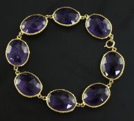 A gold and amethyst bracelet, set with eight double sided facet cut oval amethysts, approx 7.5in.