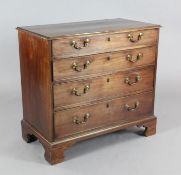 A George III mahogany chest, of four graduated long drawers, with original brass loop handles, on