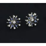 A pair of white gold, sapphire and diamond set starburst ear studs, lacking butterflies, 0.75in.
