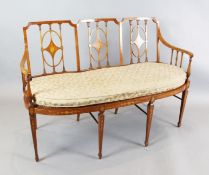 An Edwardian Period Sheraton Revival triple back inlaid satinwood settee, the triple back has vase