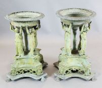 A pair of cast bronze garden urns, each modelled as a basket supported by four maidens on scallop