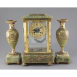 An early 20th century French ormolu mounted green onyx clock garniture, with champlevé enamel