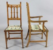 A set of eight Arts & Crafts oak dining chairs, including two carvers, with squared legs, the padded