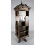 An early 20th century English Tabard Inn Library oak revolving bookcase of architectural design,