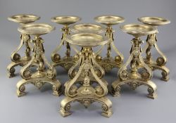 A set of eight Victorian gilt metal comport stands by Cartwright & Woodward, of tripod form, with