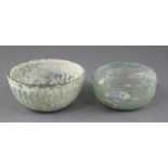 Two Roman pale green glass bowls, 2nd to 4th century AD, the larger bowl with ribbed decoration,