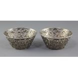 A pair of late 19th/early 20th century Chinese Export pierced repousse silver bowls, decorated