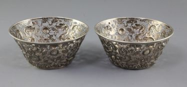 A pair of late 19th/early 20th century Chinese Export pierced repousse silver bowls, decorated