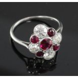 An attractive early 20th century platinum, ruby and diamond cluster ring, of lozenge form and set