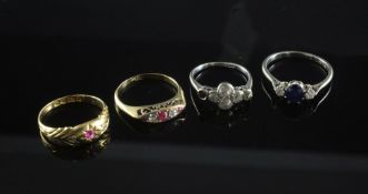 Four early 20th century 18ct gold and gem set rings, to include two ruby and diamond, a sapphire and