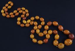 A single strand graduated oval amber bead necklace, gross 109.6 grams, 43in.