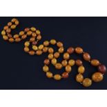 A single strand graduated oval amber bead necklace, gross 109.6 grams, 43in.