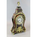 A 19th century French Louis XVI style ormolu and red boulle bracket clock, surmounted with a