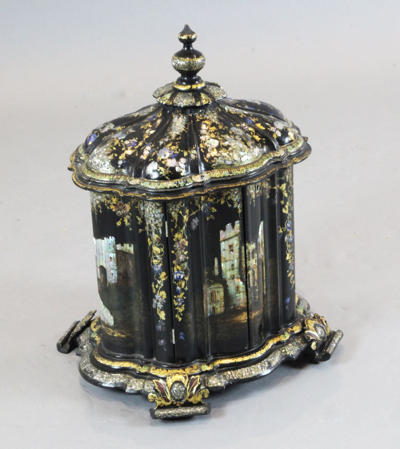 A Victorian papier mache combined jewellery and needlework casket, painted and inlaid with mother of