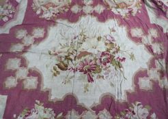 An Aubusson carpet, wine coloured field with shaped white panel of flowers to centre, reserved
