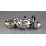 A Victorian three piece demi-fluted silver oval tea set by Stephen Smith, with engraved armorial,