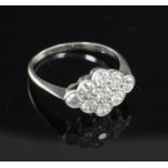 A mid 20th century 18ct white gold and nine stone diamond cluster lozenge shaped ring, size Q.