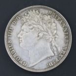 A George IV silver half crown 1821, knock to edge at 11 o'clock otherwise EF, toned