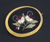 A late 19th/early 20th century Italian gold mounted pietra dura and paste oval brooch, with floral