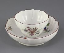 A Chelsea petal lobed tea bowl and saucer, c.1755, each painted with floral sprays and insects,