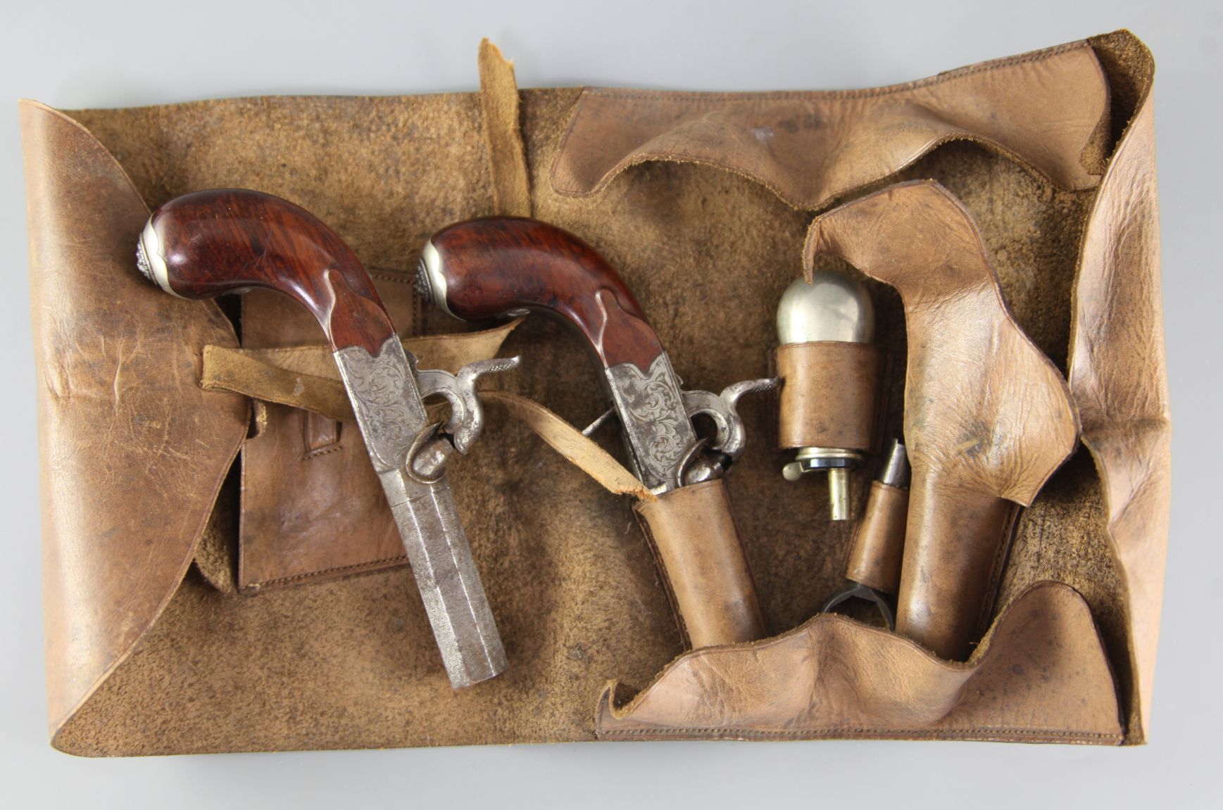 A pair of early 19th century steel boxlock pocket pistols, with simulated damascened octagonal
