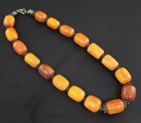 A single strand graduated amber bead necklace, with white metal spacers, gross weight 50 grams,