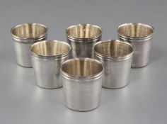 A set of six late 18th/early 19th century French 950 standard silver tots, with reeded rim, makers