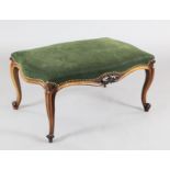 A Victorian rosewood dressing stool, with serpentine seat and cabriole legs, W.1ft 10in. D.1ft 11in.