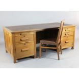 Derek 'Lizardman' Slater. An early 20th century oak desk, fitted two slides and four drawers, W.