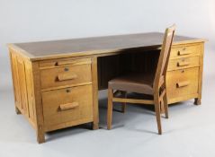 Derek 'Lizardman' Slater. An early 20th century oak desk, fitted two slides and four drawers, W.