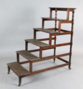 A set of Regency mahogany library steps, with six treads and fitted brass caps and castors, W.1ft