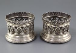 A pair of early Victorian pierced silver bottle coasters by Samuel Walker & Co, with architectural