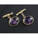A pair of 1960's 9ct gold and oval cabochon amethyst set cufflinks.