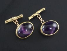 A pair of 1960's 9ct gold and oval cabochon amethyst set cufflinks.