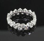 A modern white gold and claw set diamond double row full eternity ring, set with thirty two round