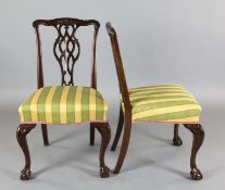 A set of twelve Edwardian Chippendale style mahogany dining chairs, with carved and pierced splats