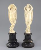 A pair of 19th century Dieppe ivory carvings of muses, standing semi-clad with arms aloft, on