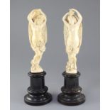A pair of 19th century Dieppe ivory carvings of muses, standing semi-clad with arms aloft, on