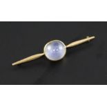 A gold and cabochon pale blue star sapphire bar brooch, 2.25in.